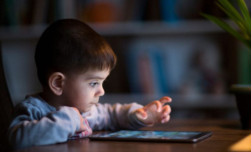 boy staring at tablet